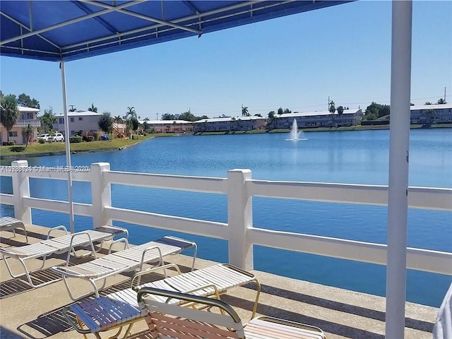 dock area featuring a water view and fence