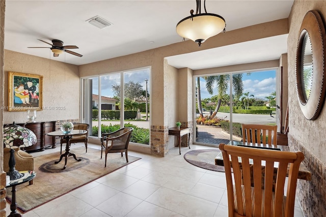 interior space with plenty of natural light, visible vents, ceiling fan, and light tile patterned flooring