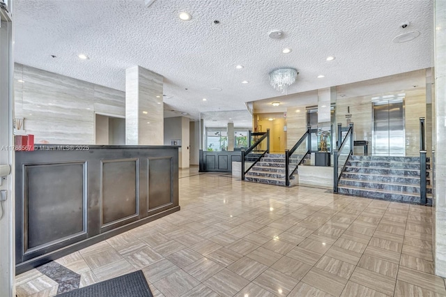 3000 Holiday Dr Unit 306, Fort Lauderdale, FL 33316 - lobby featuring a textured ceiling, stairway, and recessed lighting