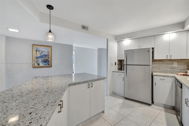 3000 Holiday Dr Unit 306, Fort Lauderdale, FL 33316 - kitchen featuring stainless steel appliances, decorative backsplash, pendant lighting, light tile patterned floors, and light stone counters
