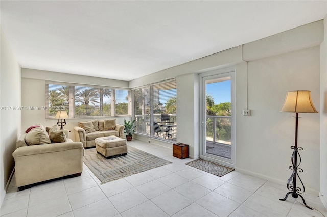 3000 Holiday Dr Unit 306, Fort Lauderdale, FL 33316 - living room with plenty of natural light, light tile patterned flooring, and baseboards