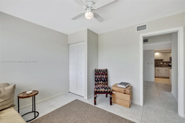 3000 Holiday Dr Unit 306, Fort Lauderdale, FL 33316 - living area with light tile patterned floors, ceiling fan, and baseboards