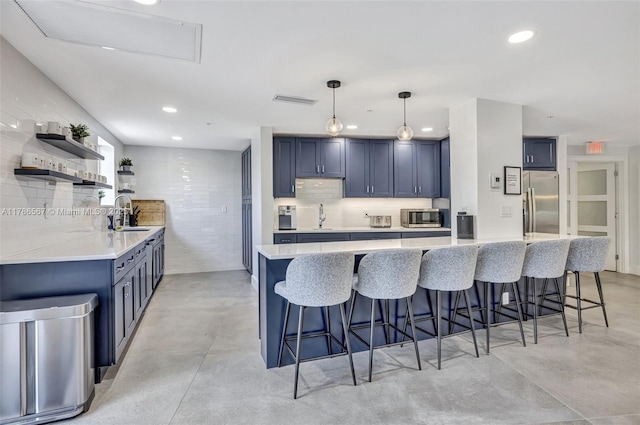 3000 Holiday Dr Unit 306, Fort Lauderdale, FL 33316 - kitchen with stainless steel appliances, concrete floors, blue cabinetry, and recessed lighting