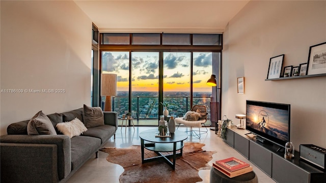 living room with concrete floors and floor to ceiling windows