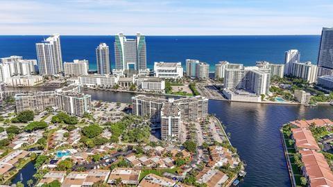 drone / aerial view of a large body of water and a skyline view