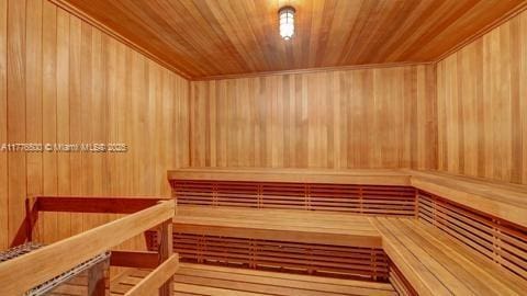 sauna featuring wooden ceiling and wood walls