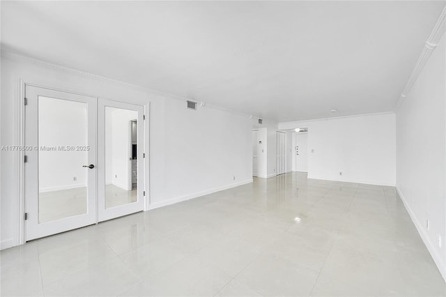 spare room featuring light tile patterned flooring, ornamental molding, baseboards, and french doors