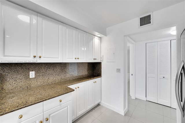 laundry room with light tile patterned flooring and baseboards