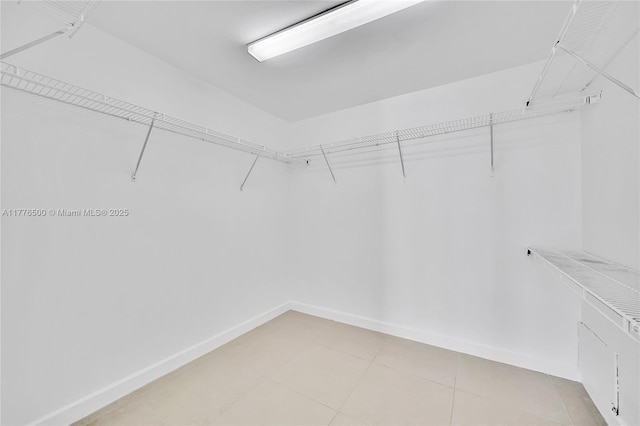 spacious closet featuring light tile patterned floors
