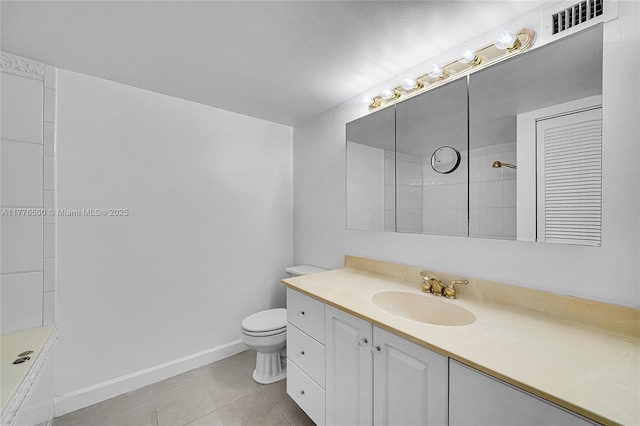 bathroom with tile patterned flooring, toilet, baseboards, vanity, and a shower