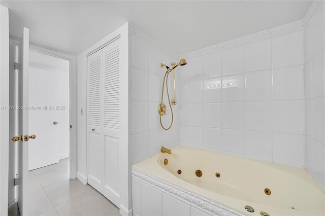 full bathroom featuring tile patterned floors, a combined bath / shower with jetted tub, and a closet
