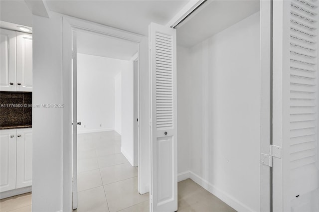 hallway featuring baseboards