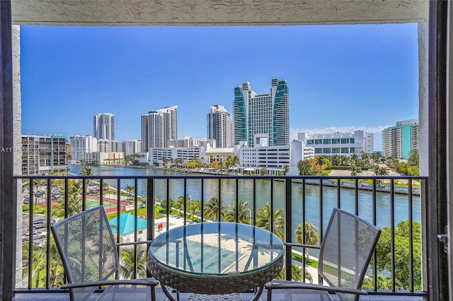 balcony with a water view and a skyline view