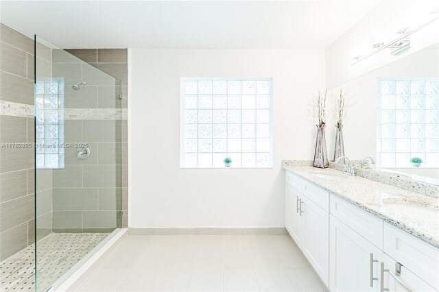 full bathroom featuring baseboards, a sink, and tiled shower