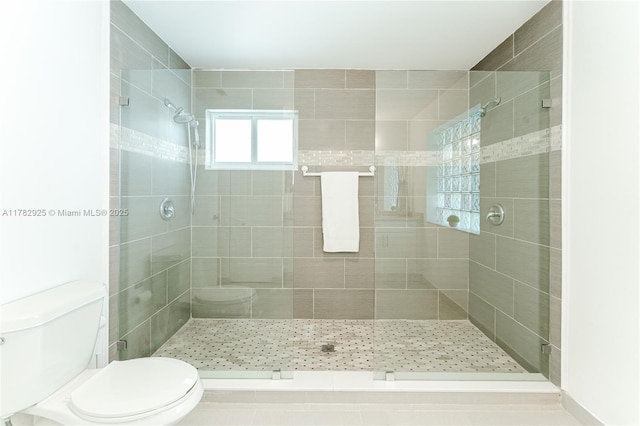 full bath featuring toilet and a stall shower