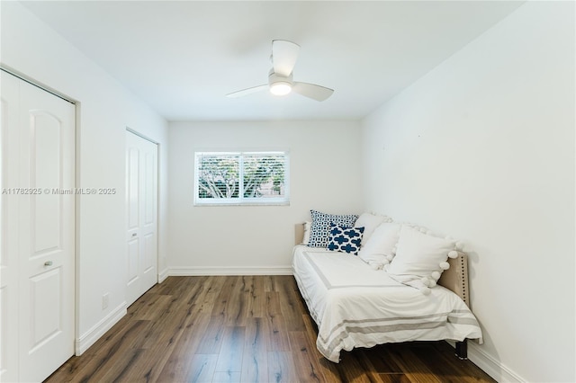 sitting room with baseboards, a ceiling fan, and wood finished floors