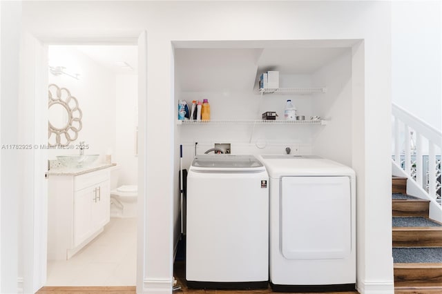 laundry area featuring washing machine and dryer, a sink, and laundry area