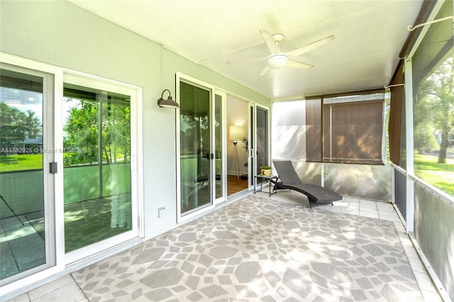 unfurnished sunroom with ceiling fan and french doors