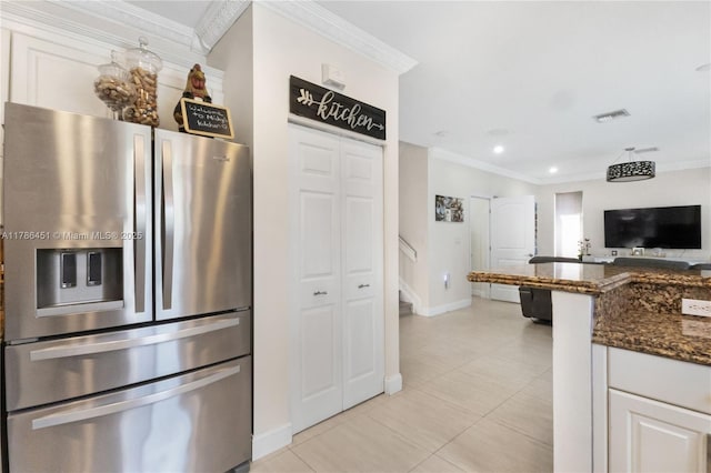 kitchen featuring baseboards, visible vents, ornamental molding, stainless steel refrigerator with ice dispenser, and light tile patterned floors