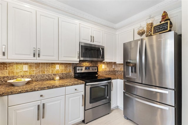kitchen featuring white cabinets, backsplash, and appliances with stainless steel finishes