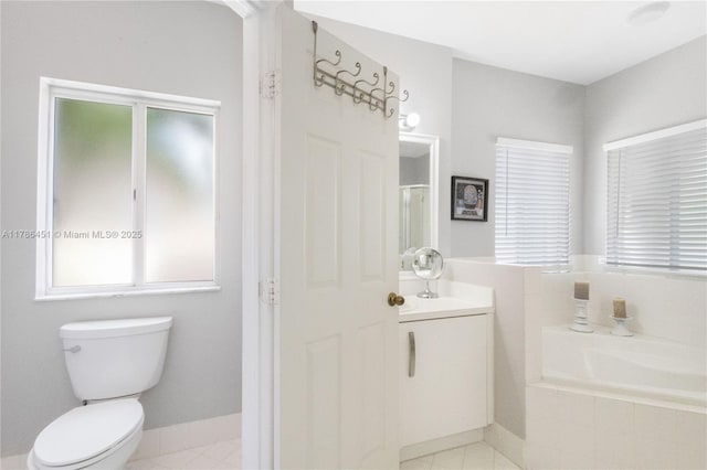 bathroom featuring a shower stall, a garden tub, tile patterned floors, vanity, and toilet