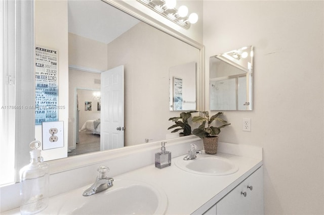 ensuite bathroom with double vanity, ensuite bathroom, and a sink