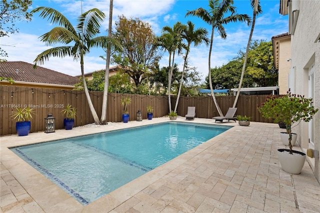 view of pool with a fenced backyard, a fenced in pool, and a patio