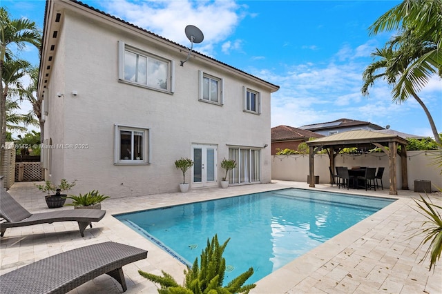 view of pool featuring a fenced backyard, a fenced in pool, a gazebo, and a patio