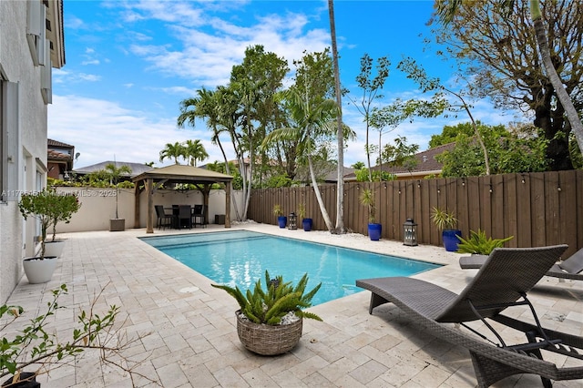 view of swimming pool with a gazebo, a patio area, a fenced in pool, and a fenced backyard