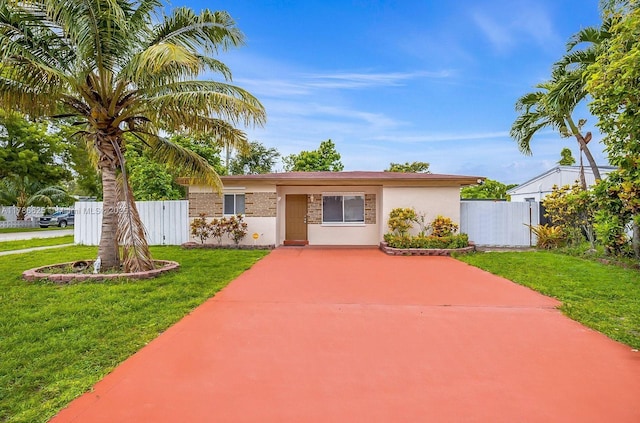 6200 Wiley St, Hollywood, FL 33023 - ranch-style home with a front lawn, concrete driveway, and fence