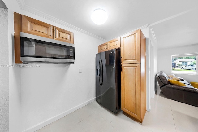 6200 Wiley St, Hollywood, FL 33023 - kitchen with black fridge with ice dispenser, baseboards, stainless steel microwave, and ornamental molding