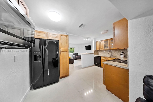 6200 Wiley St, Hollywood, FL 33023 - kitchen featuring black appliances, glass insert cabinets, a textured wall, backsplash, and visible vents