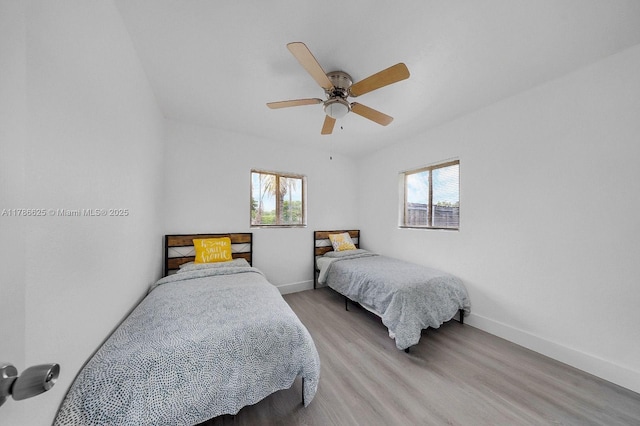 6200 Wiley St, Hollywood, FL 33023 - bedroom featuring light wood-type flooring, baseboards, ceiling fan, and multiple windows