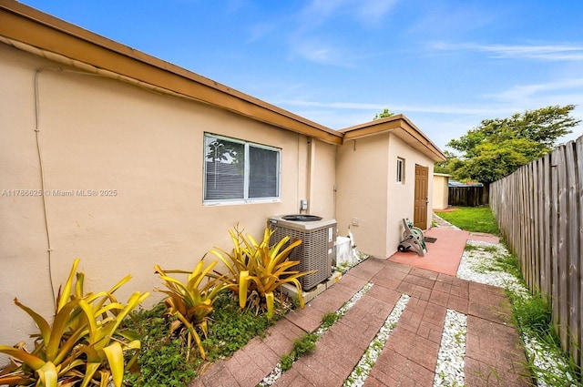 6200 Wiley St, Hollywood, FL 33023 - view of home's exterior with stucco siding, a patio, cooling unit, and a fenced backyard