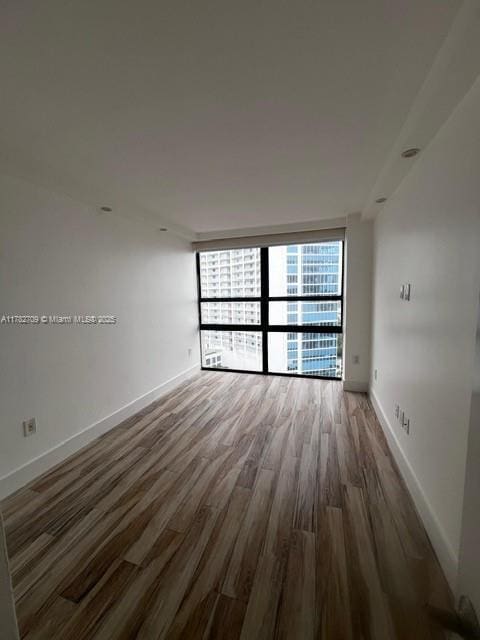 600 NE 36th St Unit 1706, Miami, FL 33137 - spare room featuring wood finished floors and baseboards