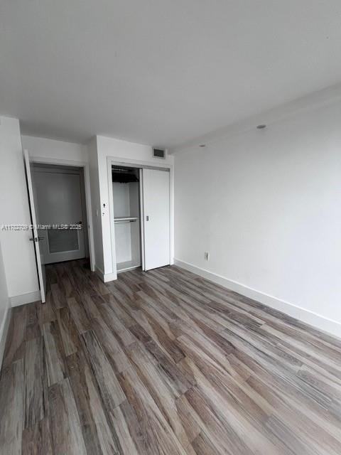 600 NE 36th St Unit 1706, Miami, FL 33137 - unfurnished bedroom with baseboards, wood finished floors, and a closet