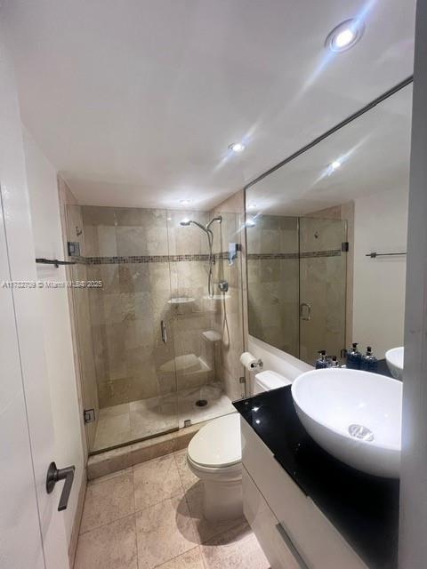 600 NE 36th St Unit 1706, Miami, FL 33137 - bathroom with a shower stall, toilet, vanity, and recessed lighting