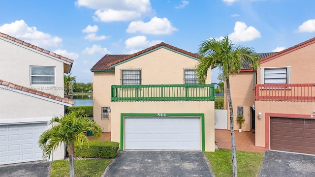 844 SW 134th Pl, Miami, FL 33184 - view of front of house featuring stucco siding, driveway, a tiled roof, and a balcony