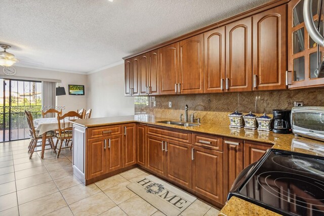 844 SW 134th Pl, Miami, FL 33184 - kitchen with a sink, a textured ceiling, black / electric stove, backsplash, and a peninsula