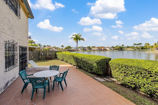 844 SW 134th Pl, Miami, FL 33184 - view of patio featuring fence, outdoor dining area, and a water view