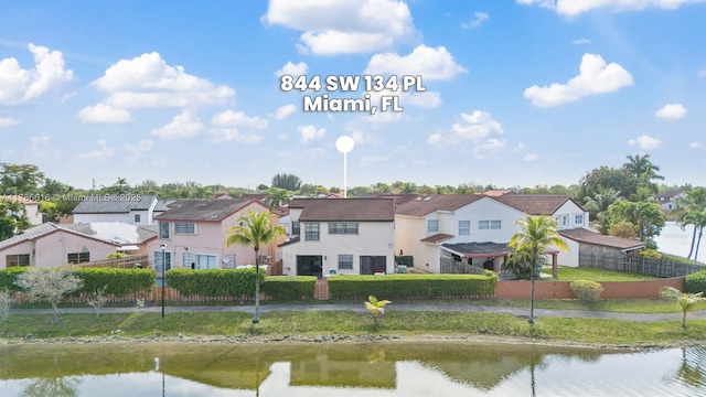 844 SW 134th Pl, Miami, FL 33184 - rear view of house featuring fence, a water view, and a residential view