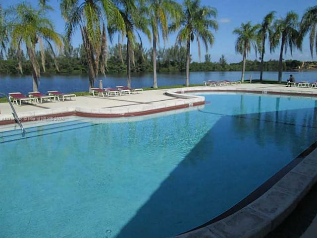 323 Ives Dairy Rd Unit 323-05, Miami, FL 33179 - pool featuring a patio area and a water view