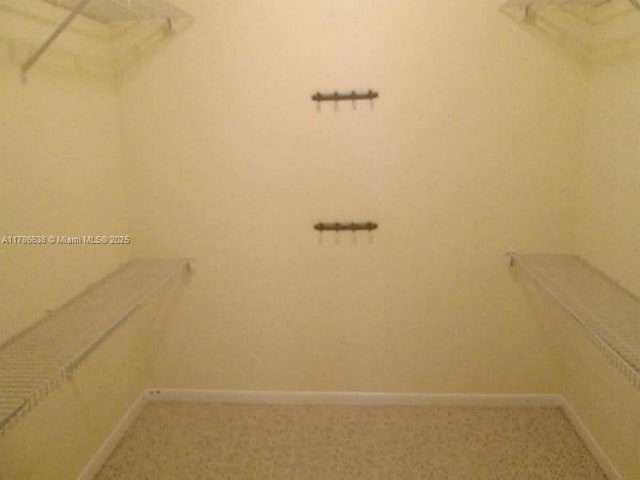 323 Ives Dairy Rd Unit 323-05, Miami, FL 33179 - walk in closet featuring light colored carpet