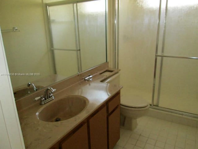 323 Ives Dairy Rd Unit 323-05, Miami, FL 33179 - bathroom with tile patterned floors, vanity, a shower stall, and toilet