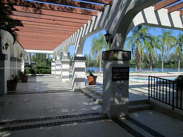 323 Ives Dairy Rd Unit 323-05, Miami, FL 33179 - exterior space with a pergola and a swimming pool