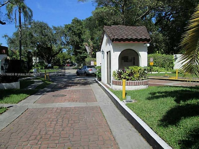 323 Ives Dairy Rd Unit 323-05, Miami, FL 33179 - exterior space with decorative driveway and a yard