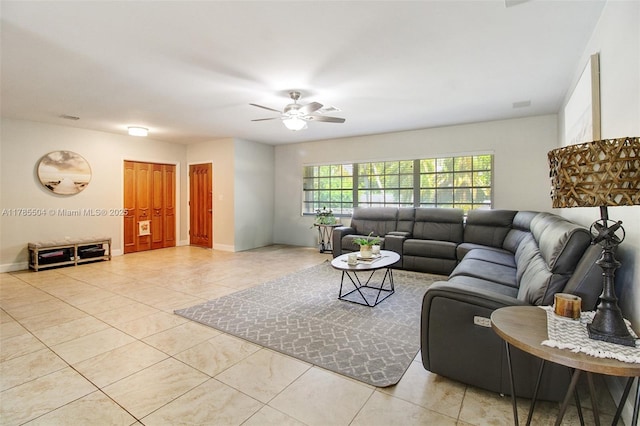 living area featuring ceiling fan and tile patterned flooring