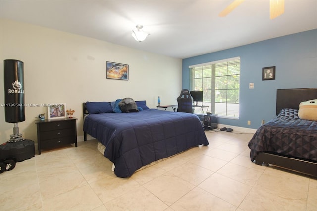 bedroom featuring light tile patterned flooring, a ceiling fan, and baseboards
