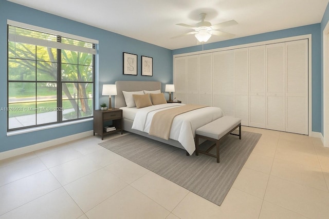 bedroom with a closet, baseboards, ceiling fan, and light tile patterned floors