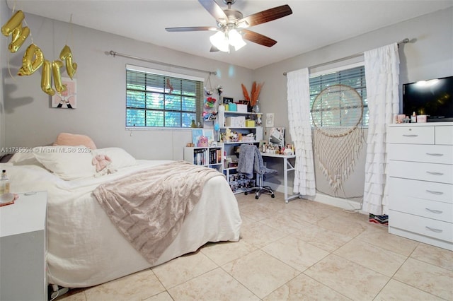 tiled bedroom with a ceiling fan